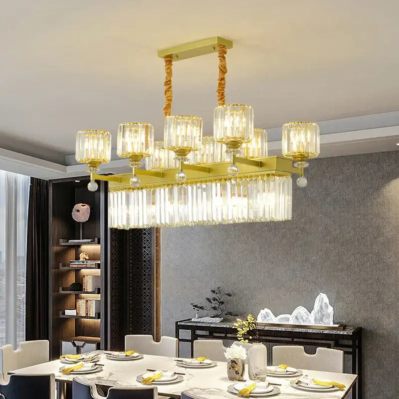 Gold-toned decorbites crystal chandelier with rectangular shape, crystal prisms, and hanging glass shades for elegant lighting