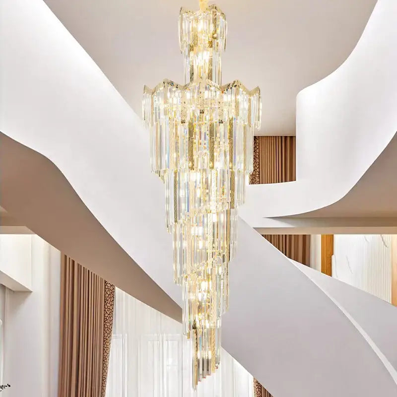 A cascading decorbites crystal chandelier with gold-toned accents and tiered faceted glass for luxury lighting