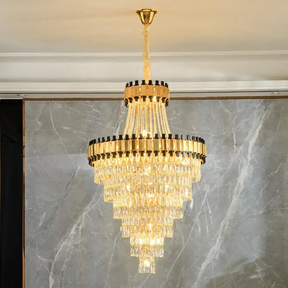 Golden tiered DecorBites crystal chandelier with cascading crystal prisms and black accents for villa hotel lighting