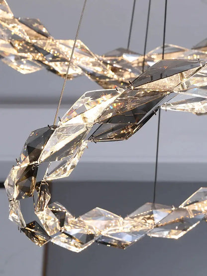 A modern decorbites crystal chandelier with faceted crystals in a spiral design for luxury living spaces