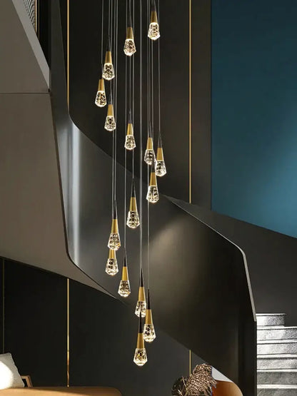 A modern decorbites crystal chandelier with gold-toned metal and crystal droplets for stairwell and living room lighting