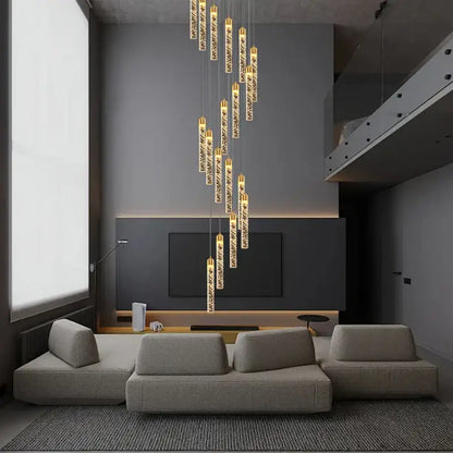 A decorbites crystal chandelier with cylindrical glass pendants and golden tops for circular stairwell lighting