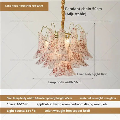 A decorbites crystal chandelier with translucent glass petals speckled in red and a braided copper chain suspension