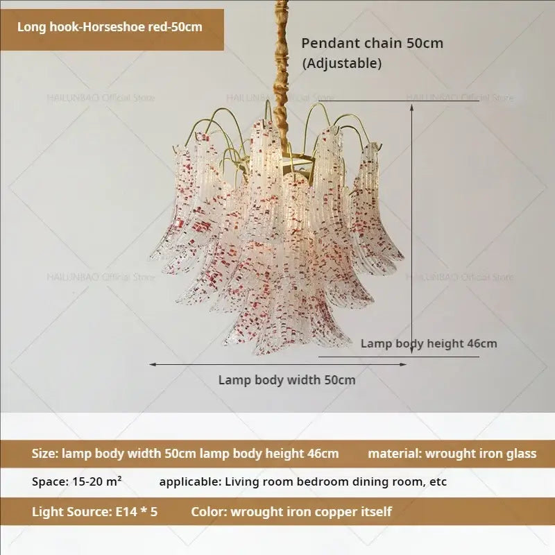 A decorbites crystal chandelier with translucent glass shades speckled in red suspended by brass wrought iron chain