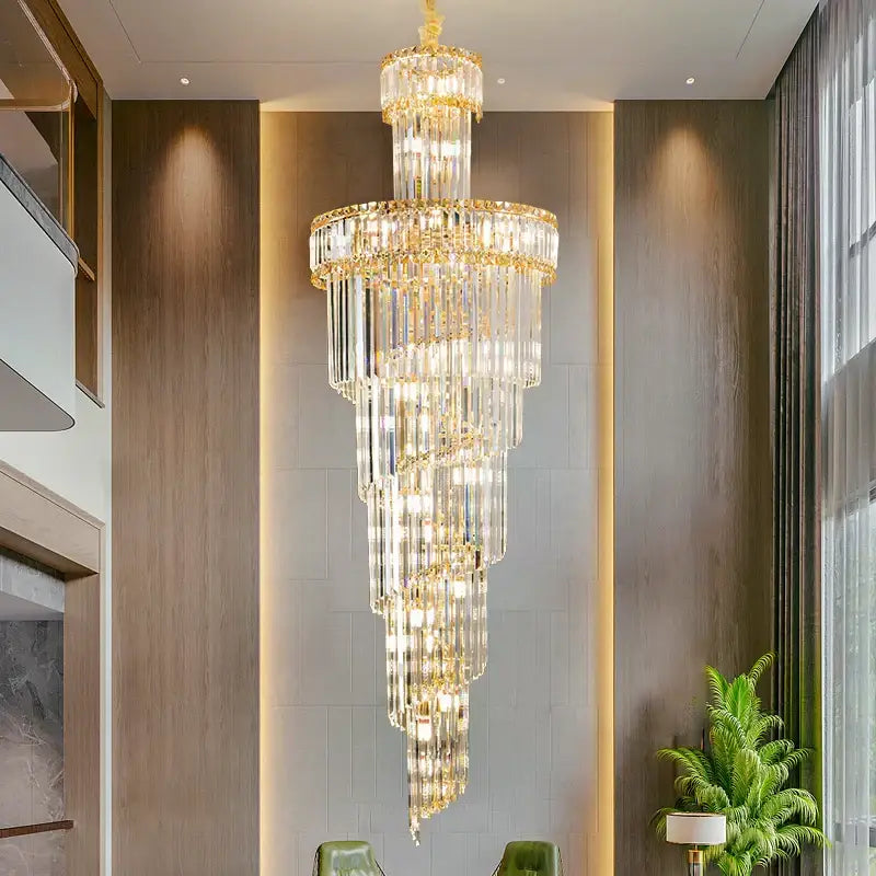 A decorbites crystal chandelier with gold-toned metal and clear glass prisms for dining room living room and master bedroom
