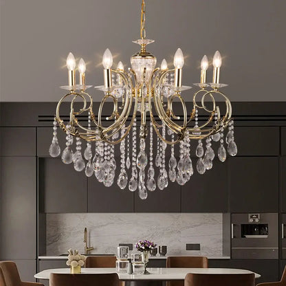 Gold-toned decorbites crystal chandelier with crystal droplets and candle-style bulbs for luxury nordic lighting