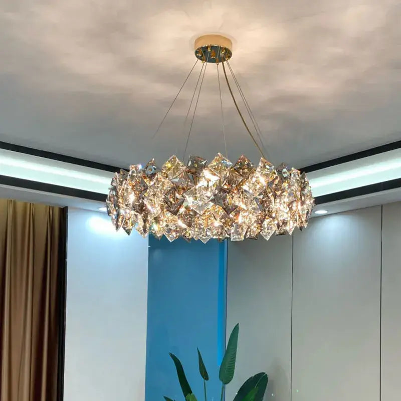 A decorbites crystal chandelier featuring faceted crystals in a circular gold-toned led pendant for living spaces