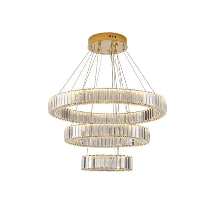 Gold-toned decorbites crystal chandelier with three concentric rings of faceted crystal segments for stair lighting