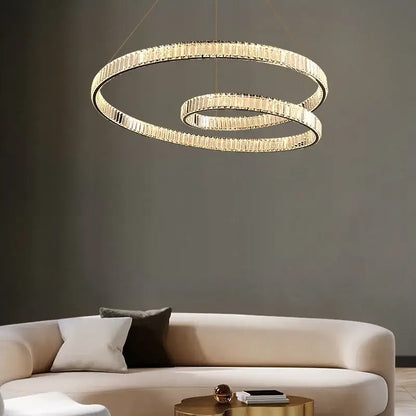 Gold-toned modern DecorBites™ crystal chandelier led light fixture with interlocking rings and faceted crystal accents