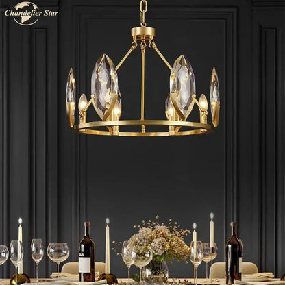 Gold-toned decorbites crystal chandelier with faceted crystal accents and circular frame for luxurious living spaces