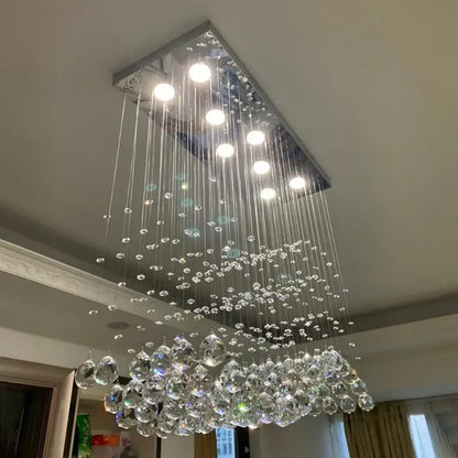 A decorbites crystal chandelier led pendant light with sleek chrome frame and cascading crystal droplets for living room use