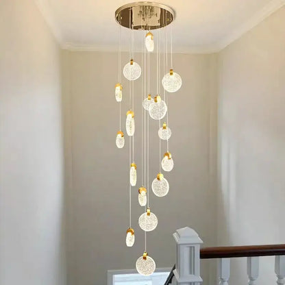 A modern decorbites crystal chandelier led pendant light with chrome mount and glass orbs for staircase lighting