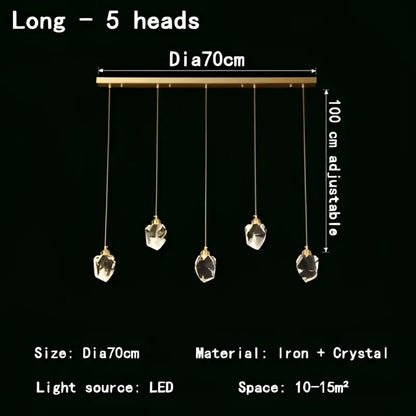 A decorbites crystal chandelier led pendant light with five faceted crystal pendants on a sleek brass iron bar
