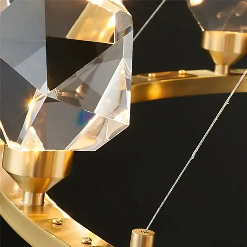 A faceted crystal pendant suspended from a gold-toned metal fixture in decorbites crystal chandelier led pendant lights