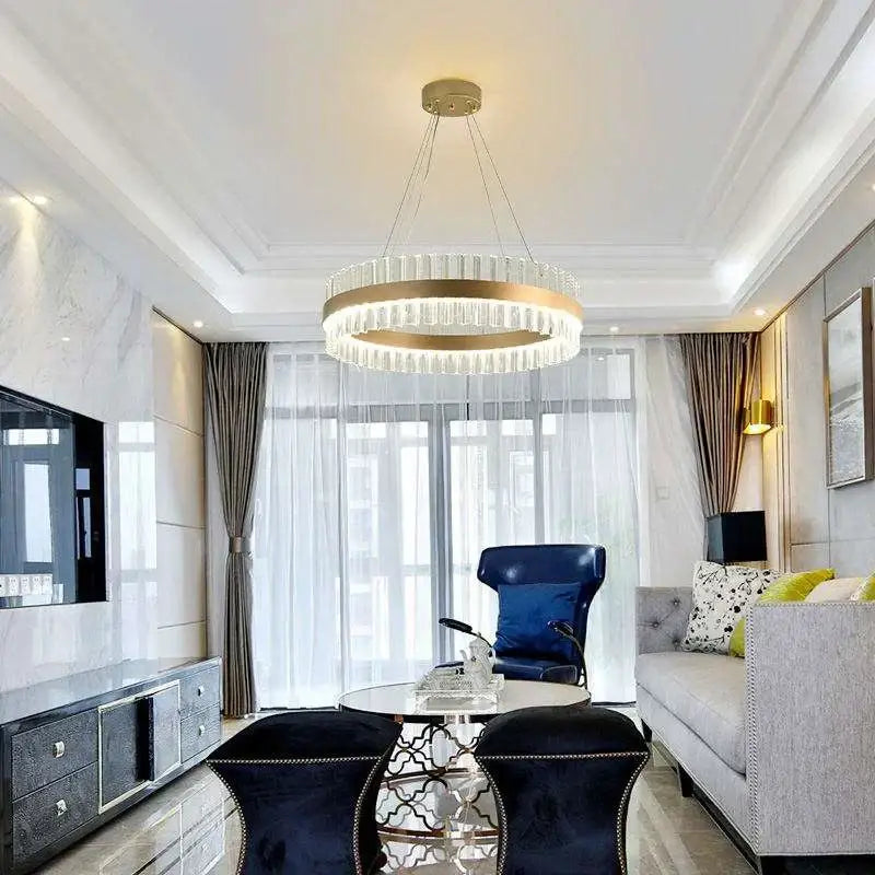 A modern decorbites crystal chandelier led with a gold-toned frame and clear crystals for dining and living rooms
