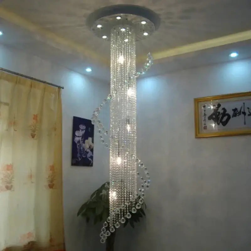 A tall, elegant decorbites crystal chandelier with spiral design and clear glass beads for luxury living room decor