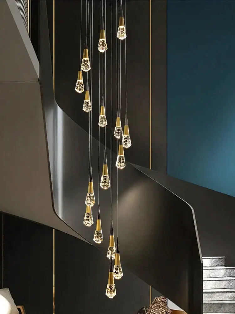A decorbites crystal chandelier led with gold-toned metal and clear crystal teardrops for staircase and living areas