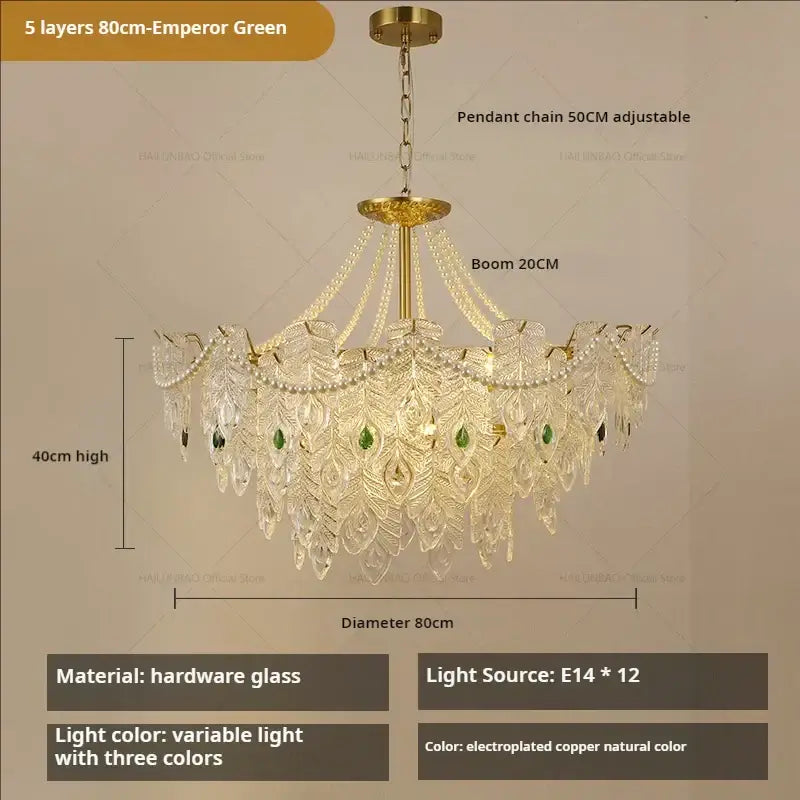 An ornate 80cm decorbites crystal chandelier with five layers of crystal peacock feather design and green gemstone accents