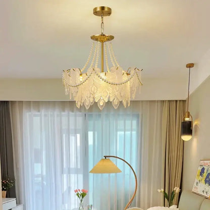 Elegant gold-toned DecorBites crystal chandelier with translucent leaf-shaped glass shades and dangling crystal beads for luxury lighting