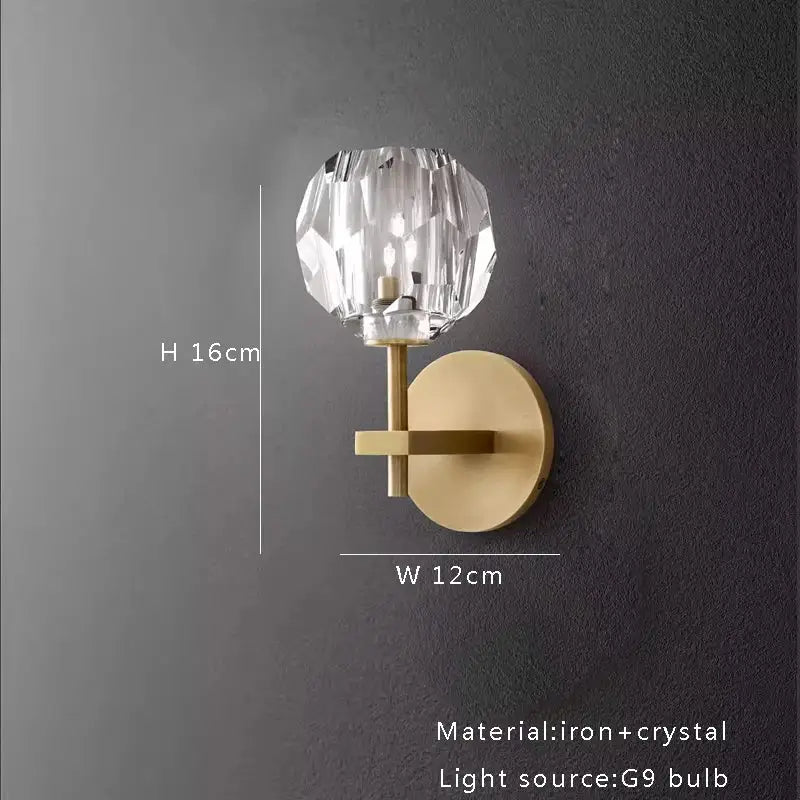 A modern wall sconce with a faceted crystal globe and brass-finished iron base for crystal chandelier lights decor