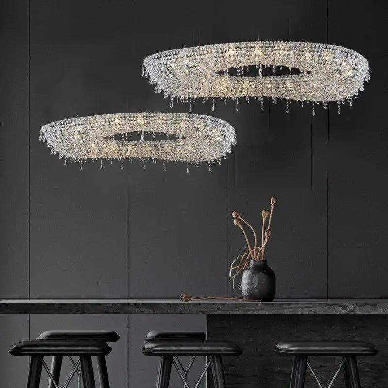 Two elegant circular decorbites crystal chandeliers with cascading droplets for indoor luxury lighting fixture design