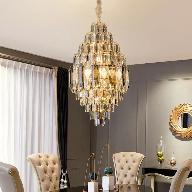 A decorbites crystal chandelier with gold-toned accents and cascading faceted glass for luxury villa and hotel lighting