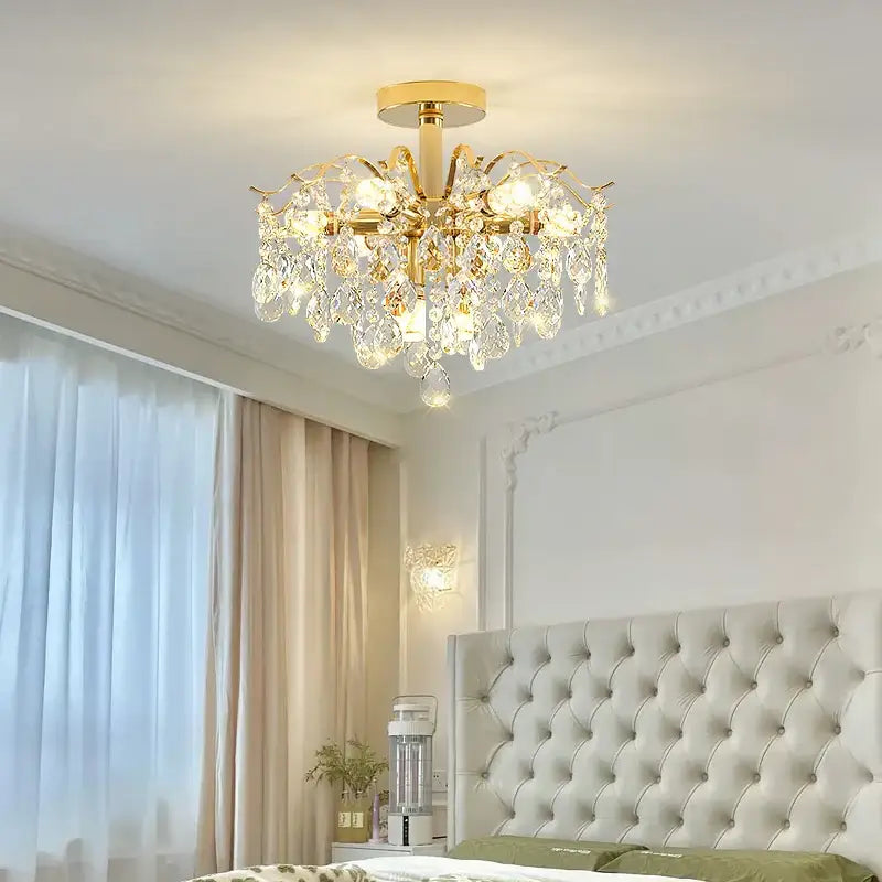 Gold-toned decorbites crystal chandelier with faceted glass pieces and central brass fixture for luxury lighting