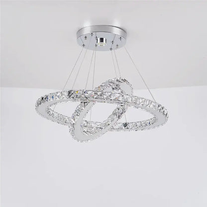 A modern chrome-finished decorbites crystal chandelier featuring two interlocking crystal rings for living and dining rooms