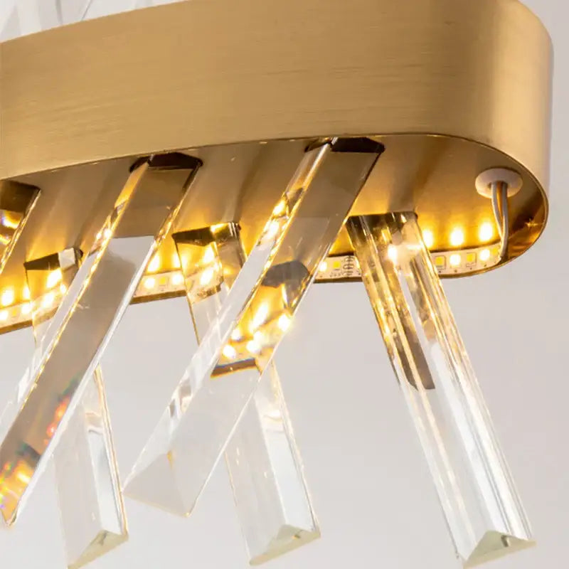 Gold-toned decorbites crystal chandelier with clear crystal prisms and embedded led lighting for luxury spaces