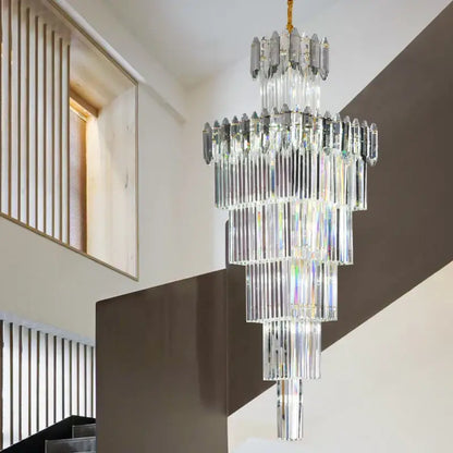 A decorbites crystal chandelier featuring multi tiered cascading clear and frosted glass rods with gold toned chain suspension