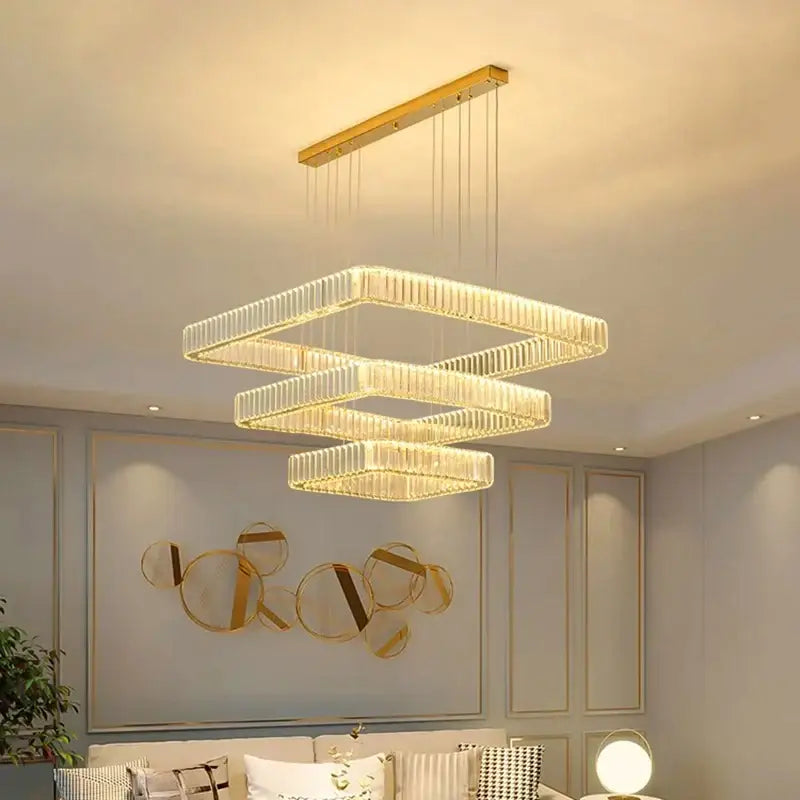 Modern gold-toned decorbites crystal chandelier with three stacked rectangular tiers for luxury living room and bedroom lighting