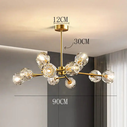 Gold-toned decorbites crystal chandelier with multiple clear faceted crystal globes for luxury living and dining rooms