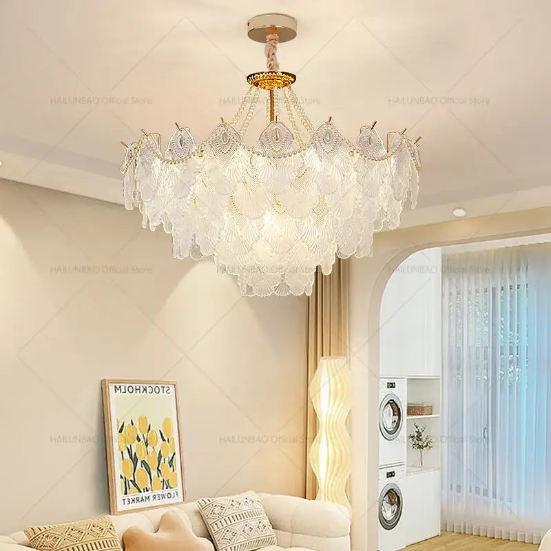 A decorbites crystal chandelier featuring multi-tiered translucent white glass shell shades with gold-toned accents for elegant living room lighting