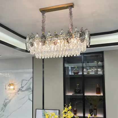Decorbites crystal chandelier with gold-toned mount and cascading clear faceted crystals for modern luxury lighting