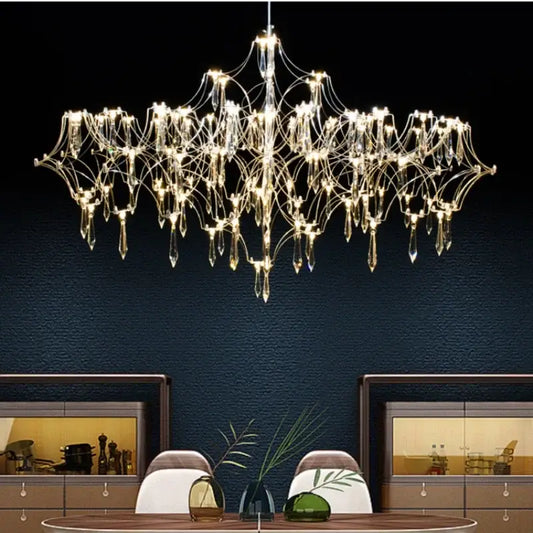 A modern decorbites crystal chandelier with metallic frame and teardrop glass pendants for luxury living spaces