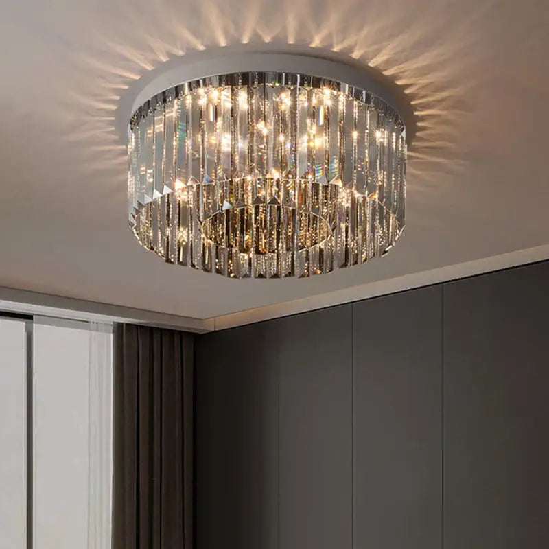 A modern decorbites crystal chandelier with cascading clear crystal prisms and a sleek white base for luxury interiors