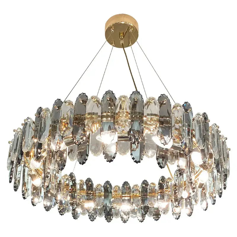 A two-tiered decorbites crystal chandelier with clear faceted crystals and gold-toned mount for living and dining rooms