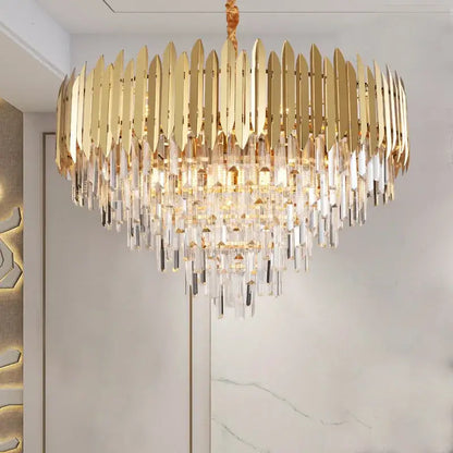 A luxurious gold-toned decorbites crystal chandelier with cascading prisms for modern dining room or bedroom lighting
