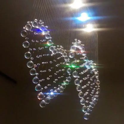 A decorbites crystal chandelier shaped like a swan with clear teardrop and round crystals for modern lighting