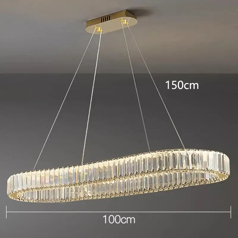 A modern decorbites crystal chandelier with oval gold frame and two concentric rings of clear crystal prisms for living room