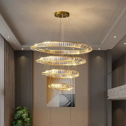 A modern decorbites crystal chandelier with multi-tiered golden rings encrusted in clear crystals for living room lighting