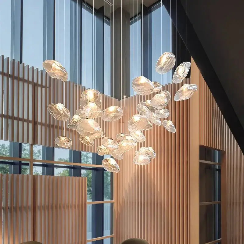 A modern decorbites crystal chandelier with translucent irregular glass orbs for living room stair lighting