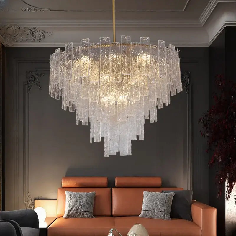 A modern decorbites crystal chandelier with cascading textured glass panels and gold-toned rod for home decor lighting