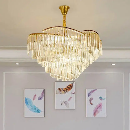 A luxurious gold-toned decorbites crystal chandelier with cascading crystal prisms for living room and bedroom use