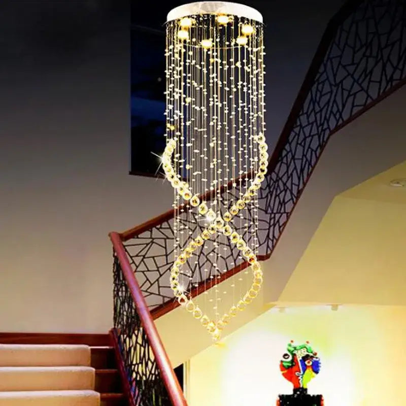 A sparkling gold-toned decorbites crystal chandelier with cascading strands and circular top for villa hall lighting