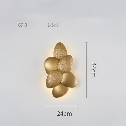 Gold-colored textured flower-shaped wall sconce with modern design complementing decorbites crystal chandelier decor