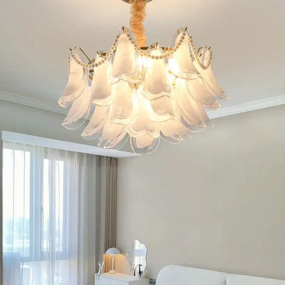 A delicate translucent white glass decorbites crystal chandelier with a golden frame and beads for modern luxury lighting