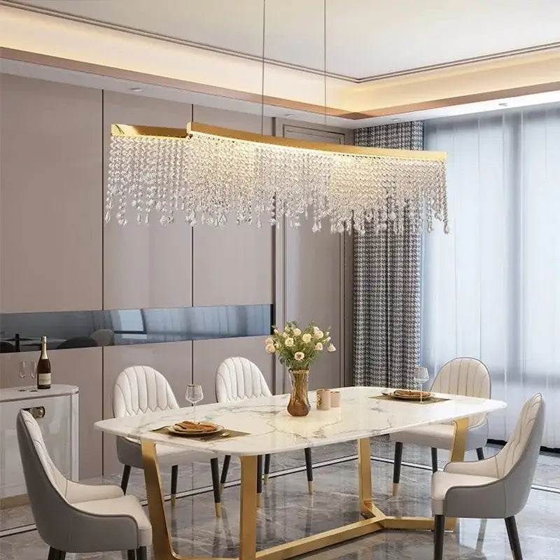 Gold-toned rectangular decorbites crystal chandelier with cascading crystal droplets for modern living and dining rooms