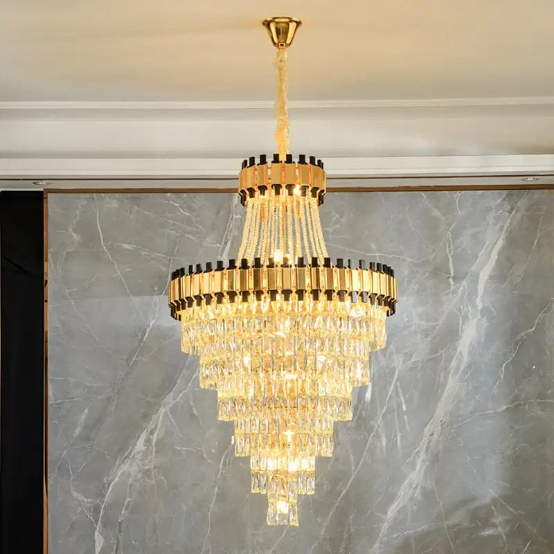 Golden tiered decorbites crystal chandelier with cascading crystal prisms and black accents for luxury venues