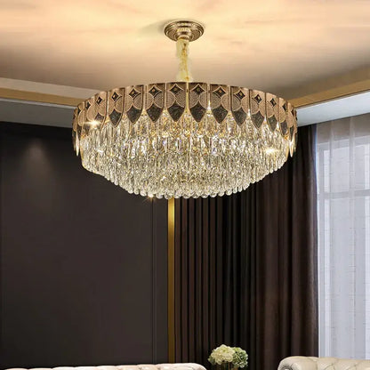 A gold-toned decorbites crystal chandelier with intricate geometric patterns and cascading clear droplets for modern luxury